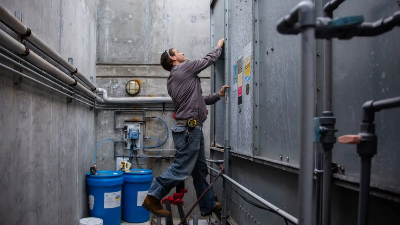 HVAC technician performing water heater service